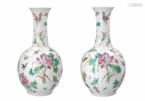 A pair of polychrome porcelain vases, decorated with flowers and insects. Marked with seal mark