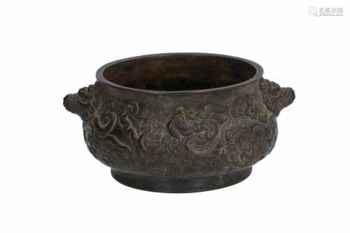 A bronze censer with relief decor of dragons and clouds. The handles in the shape of animal heads.