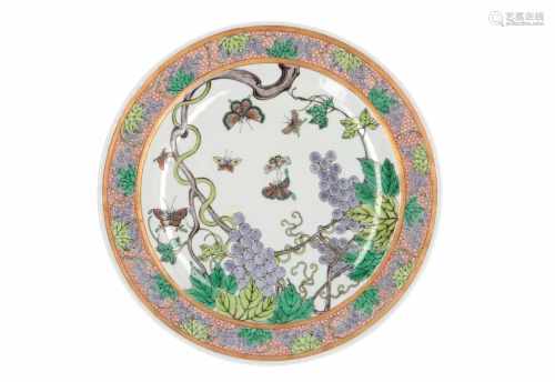 A polychrome porcelain dish, decorated with butterflies and fruits. Made in 1954. Marked with 6-