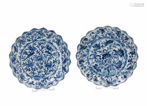 A pair of blue and white porcelain saucers with scalloped and ribbed rim, decorated with flowers and