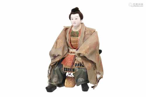 A musha ningyo doll of Emperor Ojin sitting on a folding chair. Japan, 19th/20th century. H. 47 cm.