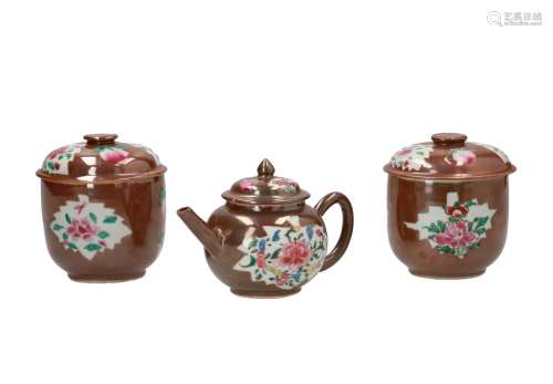 A capucine porcelain teapot and two lidded jars, decorated with flowers and fruits. Unmarked. China,