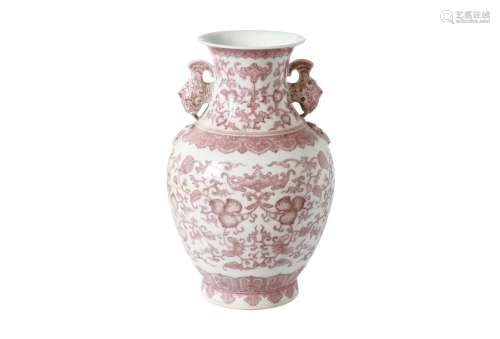 An underglaze red and white porcelain vase, decorated with flowers. The handles in the shape of