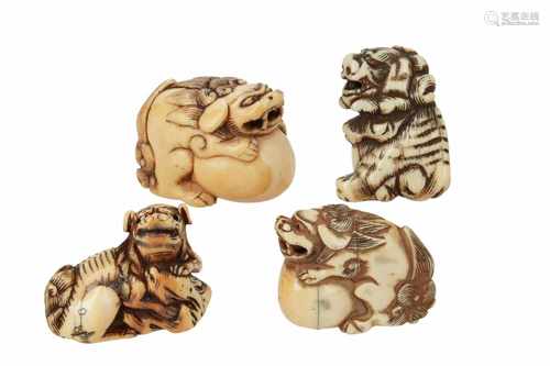 Lot of four netsuke, 1) Ivory reclining shishi with cub. L. 4,5 cm. 2) Ivory shishi with ball and