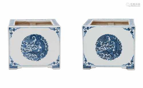 A pair of square blue and white porcelain cachepots, decorated with flowers and mythical animals.