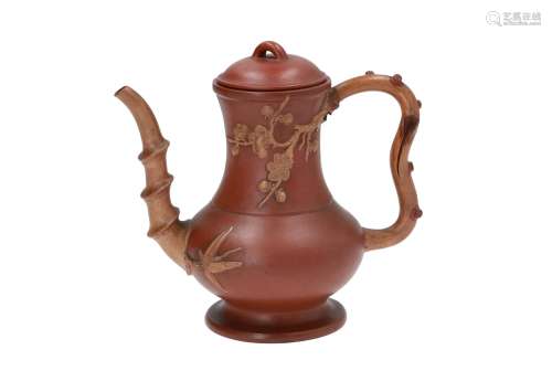 A baluster shaped Yixing teapot, decorated with flowers in relief. With handle and spout in the