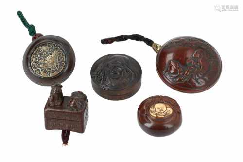 Lot of five manju, 1) Wooden, depicting a shishi and figure with hat. With hidden seal under the