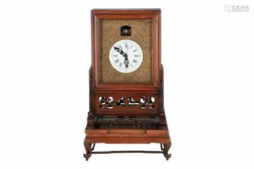 A wooden clock on stand with rotating mechanism. China, 19th century. H. incl. stand 35 cm.