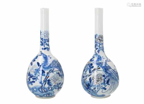 A pair of blue and white porcelain longneck vases, decorated with phoenix and peonies. Unmarked.