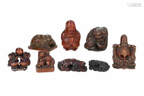 Lot of eight netsuke, 1) Wooden shishi with cubs on base. Signed Masamitsu. H. 3 cm. 2) Wood with