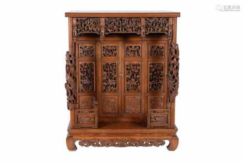 A wooden altar cabinet, the doors with twelve finely carved panels, pillars and fence, with decor of