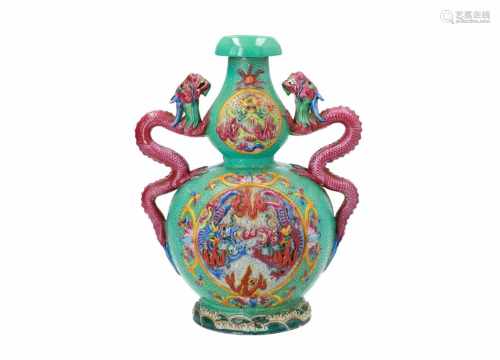 A polychrome porcelain vase, decorated with dragons in relief. The handles in the shape of