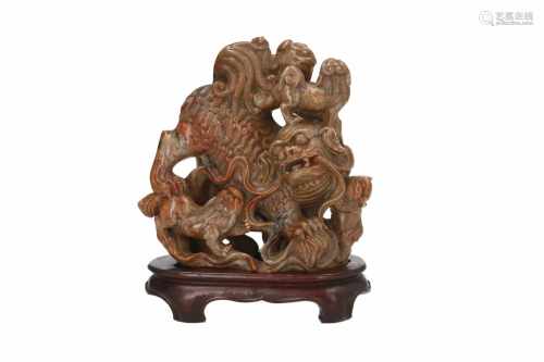 A soapstone sculpture on wooden base, depicting a temple lion with four cubs. China, Qing,