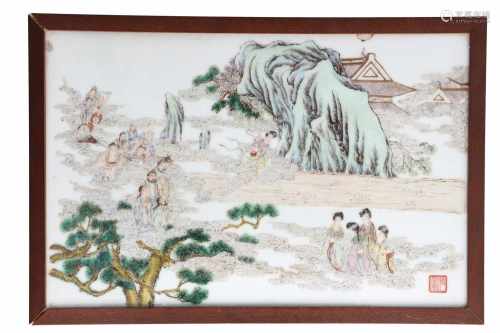 A polychrome porcelain plaque in wooden frame, depicting figures on clouds, a mountain and a