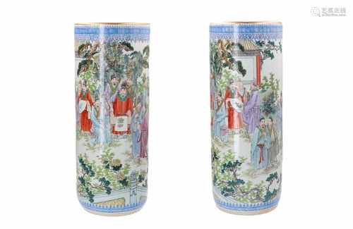 A pair of polychrome porcelain vases, decorated with figures in a garden and a poem. Signed Cao