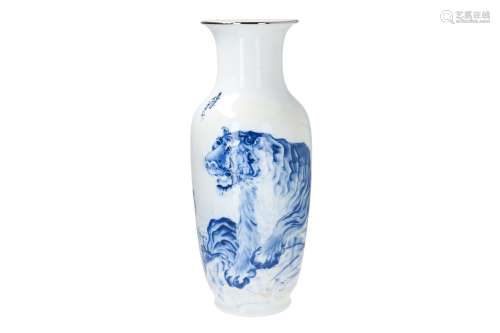A large blue and white porcelain vase with gilded rim, decorated with a tiger on a rock and