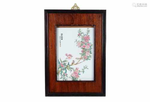 A polychrome porcelain plaque in wooden frame, depicting birds, flowers and characters. Made in