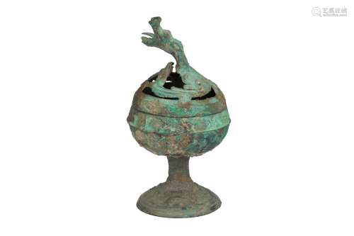 A bronze boshanlu incense burner. The handle of the lid in the shape of a dragon. The foot with