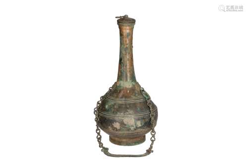 A bronze bottle shaped Hu vase with slender neck and cover. China, Han, 206 BC - AD 220 or later. H.