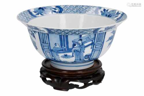 A blue and white porcelain 'klapmuts' bowl on wooden stand, decorated with figures, little boys