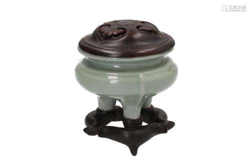 A celadon tripod censer with wooden lid and base. Unmarked. China, Longquan, late Ming. H. censer