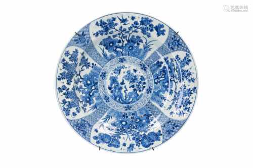 A blue and white porcelain charger, decorated with flowers. Marked with seal mark. China, Kangxi.
