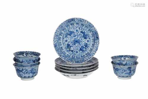 A set of five blue and white porcelain cups with saucers, decorated with flowers, crabs and fish.