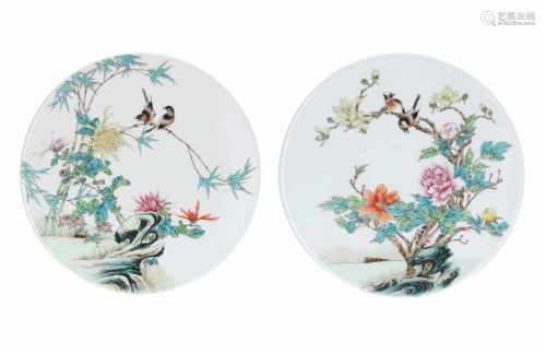 A lot of two round polychrome porcelain plaques, both decorated with flowers and birds. Made in