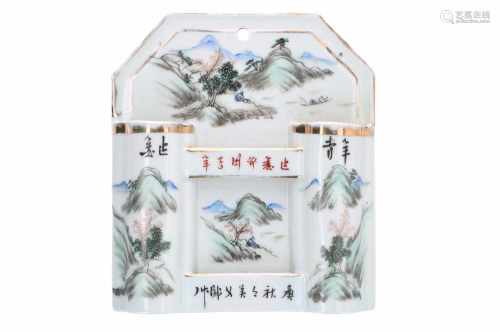 A polychrome porcelain match holder, decorated with a mountainous landscape and characters.