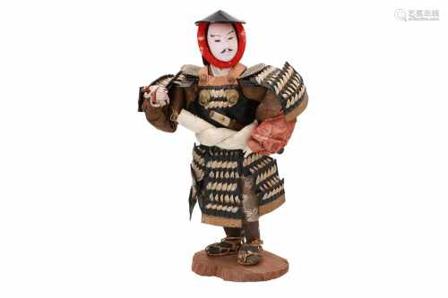A doll of a Japanese standing samurai warrior with a banner. Japan, 19th/20th century. H. excl.