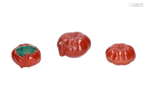 A set of coral red glazed objects, including a brush washer, water dropper and a sealing wax box. In
