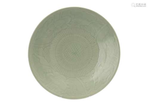 A celadon glazed dish, decorated with flowers and leafs. The rim and ring unglazed. Unmarked. China,