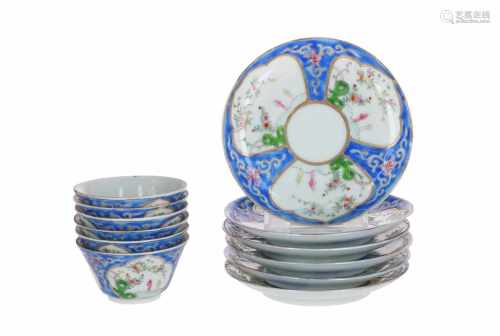 A set of six polychrome porcelain cups with saucers, decorated with figures in a garden. Unmarked.