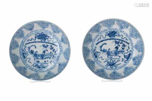 Lot of two blue and white porcelain deep dishes, decorated with flowers and tea ceremony scene.