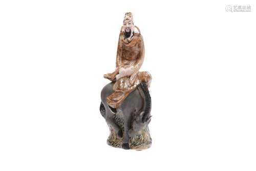 A polychrome porcelain sculpture of a man with scroll, sitting on a horse. Dated 1998. Created by Xu