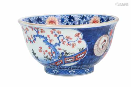 An Imari porcelain bowl, decorated with a turtle, bird and pagoda in reserves. The center with a