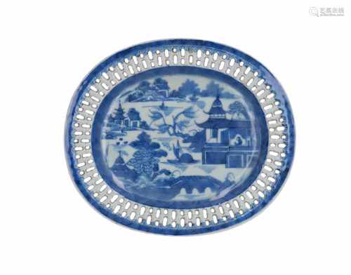An oval blue and white porcelain serving dish with open work rim, decorated with river landscape and