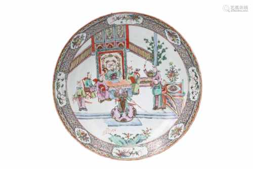 A large polychrome porcelain deep charger, decorated with figures in a terrace garden. Marked with