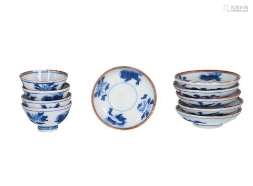 A lot of six blue and white porcelain saucers and four cups, decorated with flowers. Marked with 6-