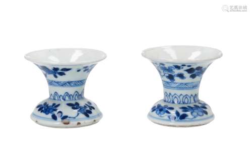 A pair of blue and white porcelain candlesticks, decorated with flowers. Marked with artemisia leaf.