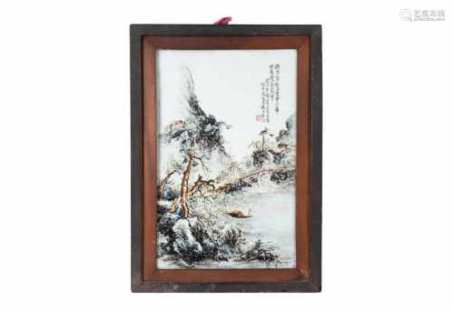 A polychrome porcelain plaque in wooden frame, depicting a mountainous river landscape with