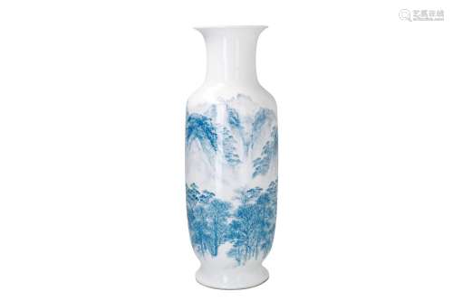 A blue and white porcelain vase, decorated with a mountainous landscape with houses. Marked with