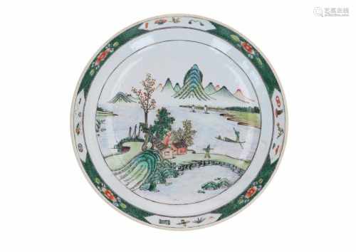 A famille verte porcelain charger, decorated with a mountainous river landscape. Unmarked. China,