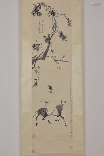 A Chinese ink painting in scroll of man on donkey.