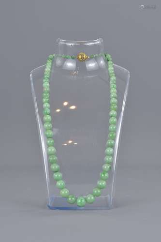 A string of graduated jadeite beads.