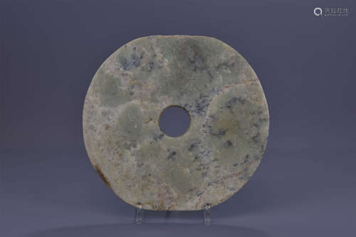 A large Chinese Neolithic or later jade disc head.