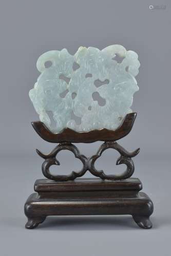 A Chinese Jadeite carving of two bats on wooden st