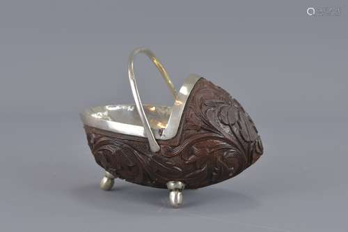 A Colonial silver and carved nut basket. 11cm leng