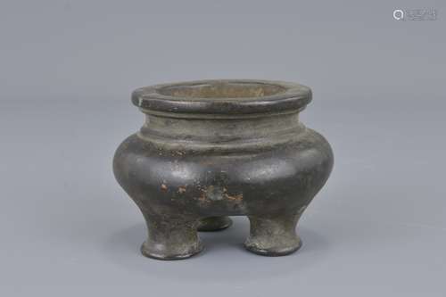 A small Chinese bronze three-legged desk censer wi