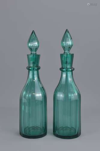 A pair of Aqua Green liquor glass bottles with sto